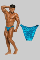Thefreeway DN109 turquoise laminated competition bodybuilding posing trunks worn by a male bodybuilder with standalone product view